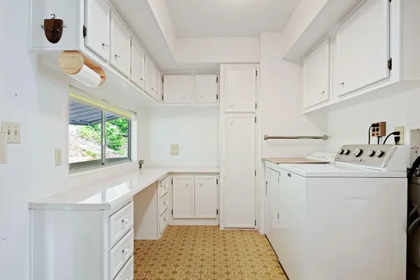 a kitchen with a sink a window and cabinets