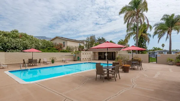 an outdoor space with furniture and umbrella