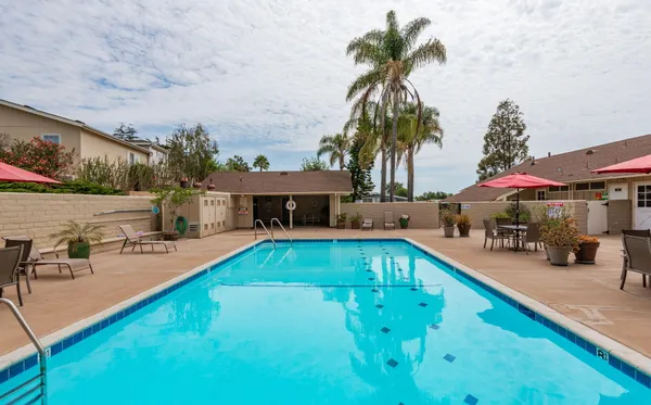 a swimming pool view with a outdoor seating