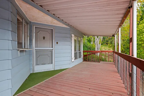 a view of a balcony with wooden floor