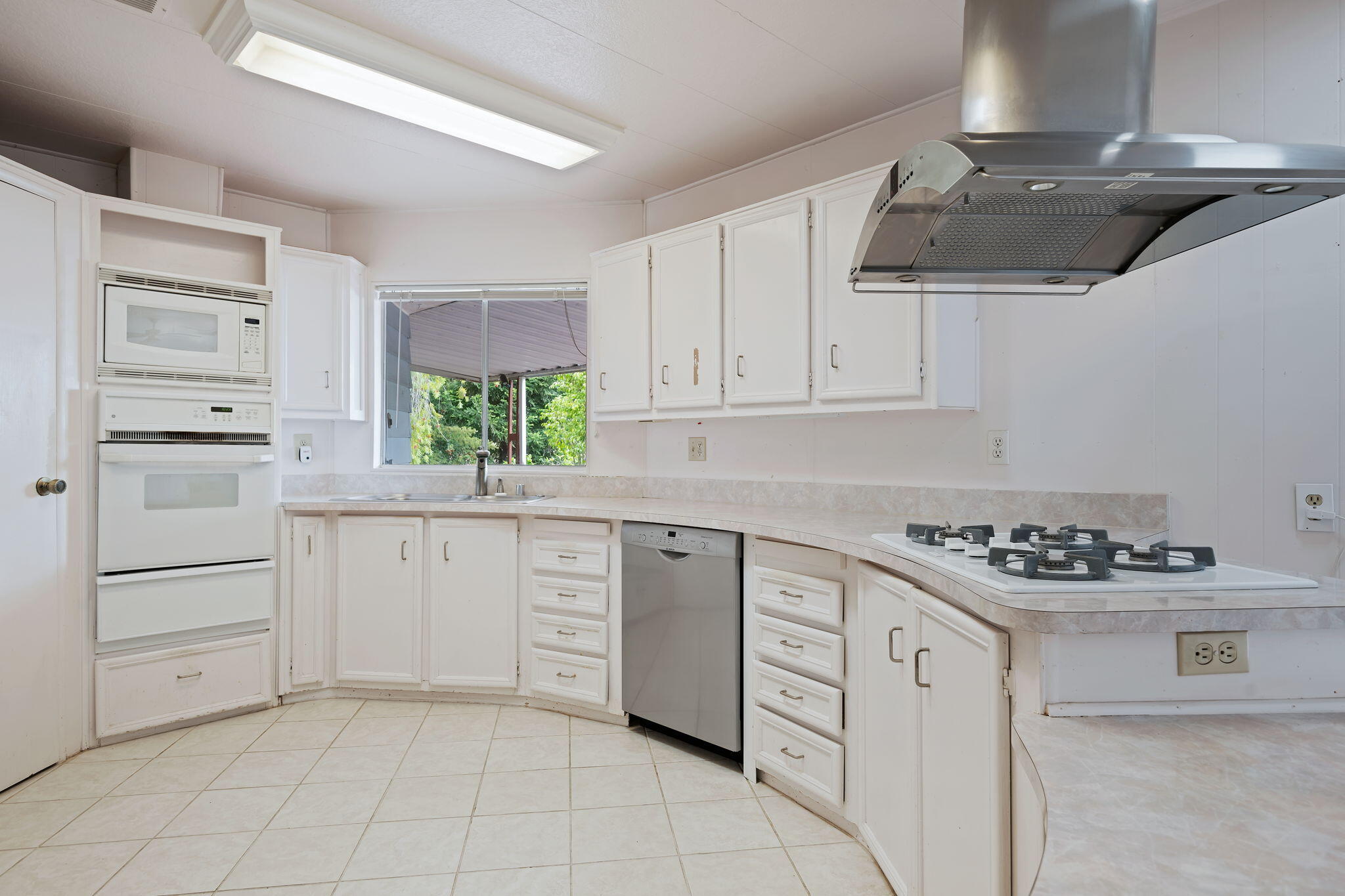 340 Old Mill Road, Unit 127 Santa Barbara, CA 93110 - Photo 9 of 33 a kitchen with white cabinets and appliances
