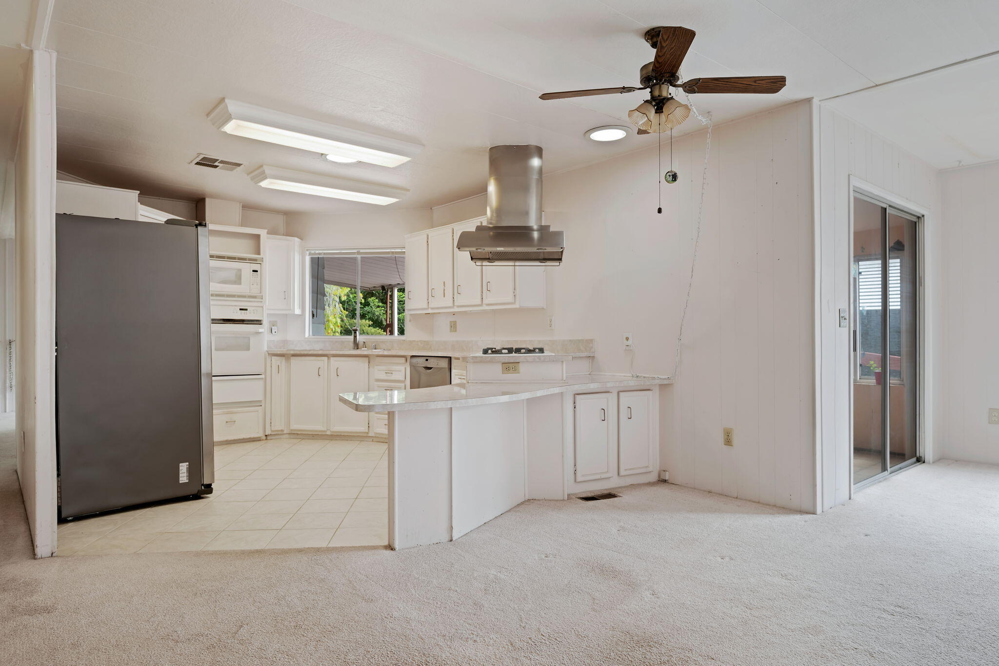 340 Old Mill Road, Unit 127 Santa Barbara, CA 93110 - Photo 10 of 33 a kitchen with white cabinets and refrigerator