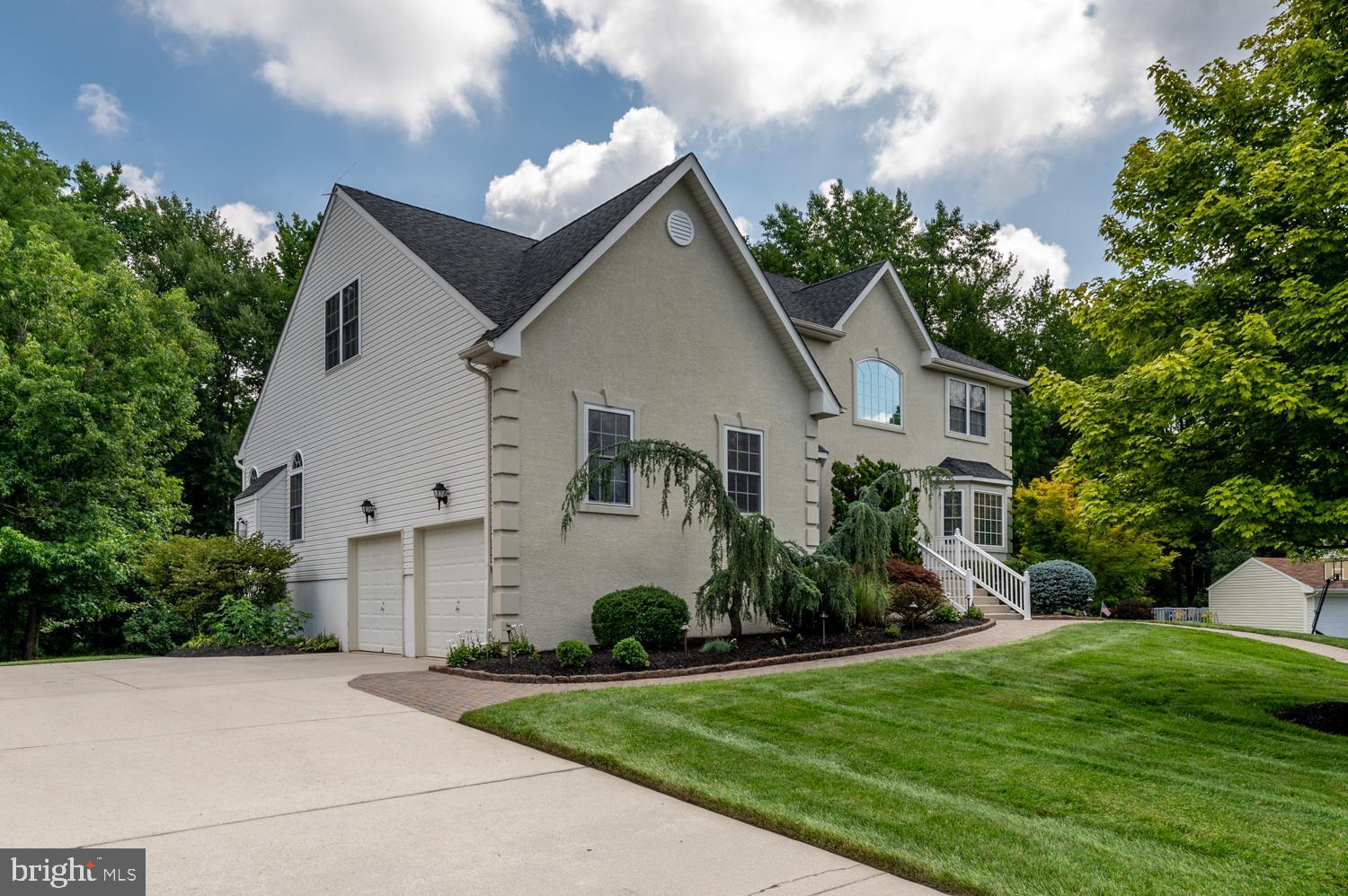 11 Gaskill Road Mount Laurel, NJ 08054 - Photo 3 of 56 a front view of a house with a yard and a garage