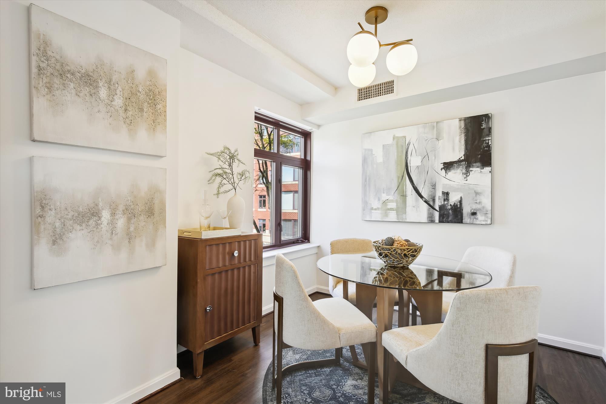 2400 Clarendon Boulevard, Unit 414 Arlington, VA 22201 - Photo 16 of 39 a view of a dining room with furniture window and wooden floor