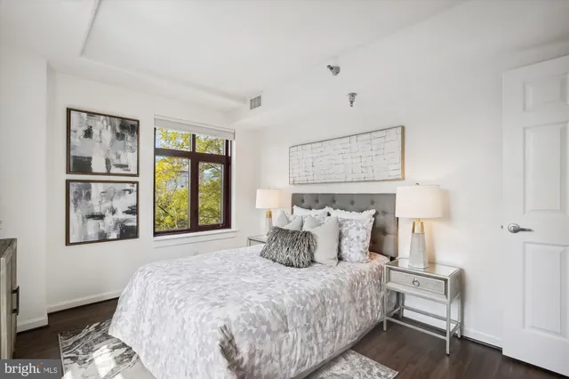 a bathroom with a granite countertop toilet a sink and a mirror