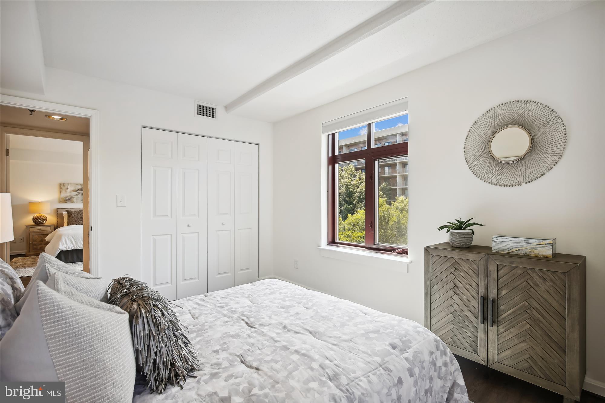 2400 Clarendon Boulevard, Unit 414 Arlington, VA 22201 - Photo 20 of 39 a bedroom with a bed and a dresser