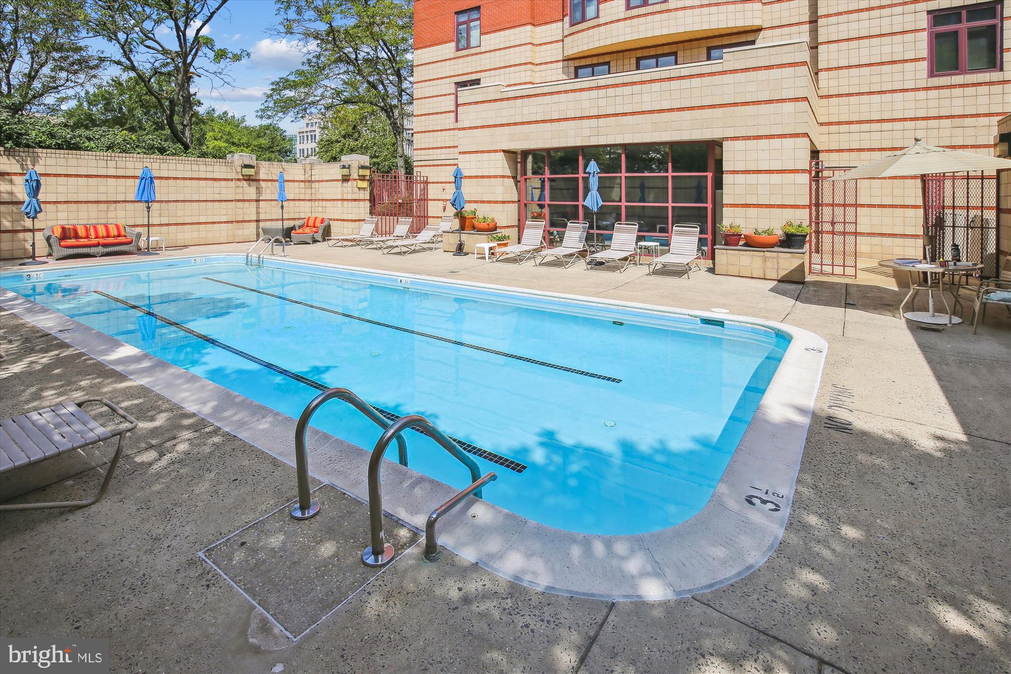 2400 Clarendon Boulevard, Unit 414 Arlington, VA 22201 - Photo 31 of 39 a view of a swimming pool with a lounge chair