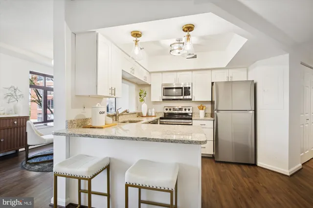 a kitchen with a refrigerator sink and microwave