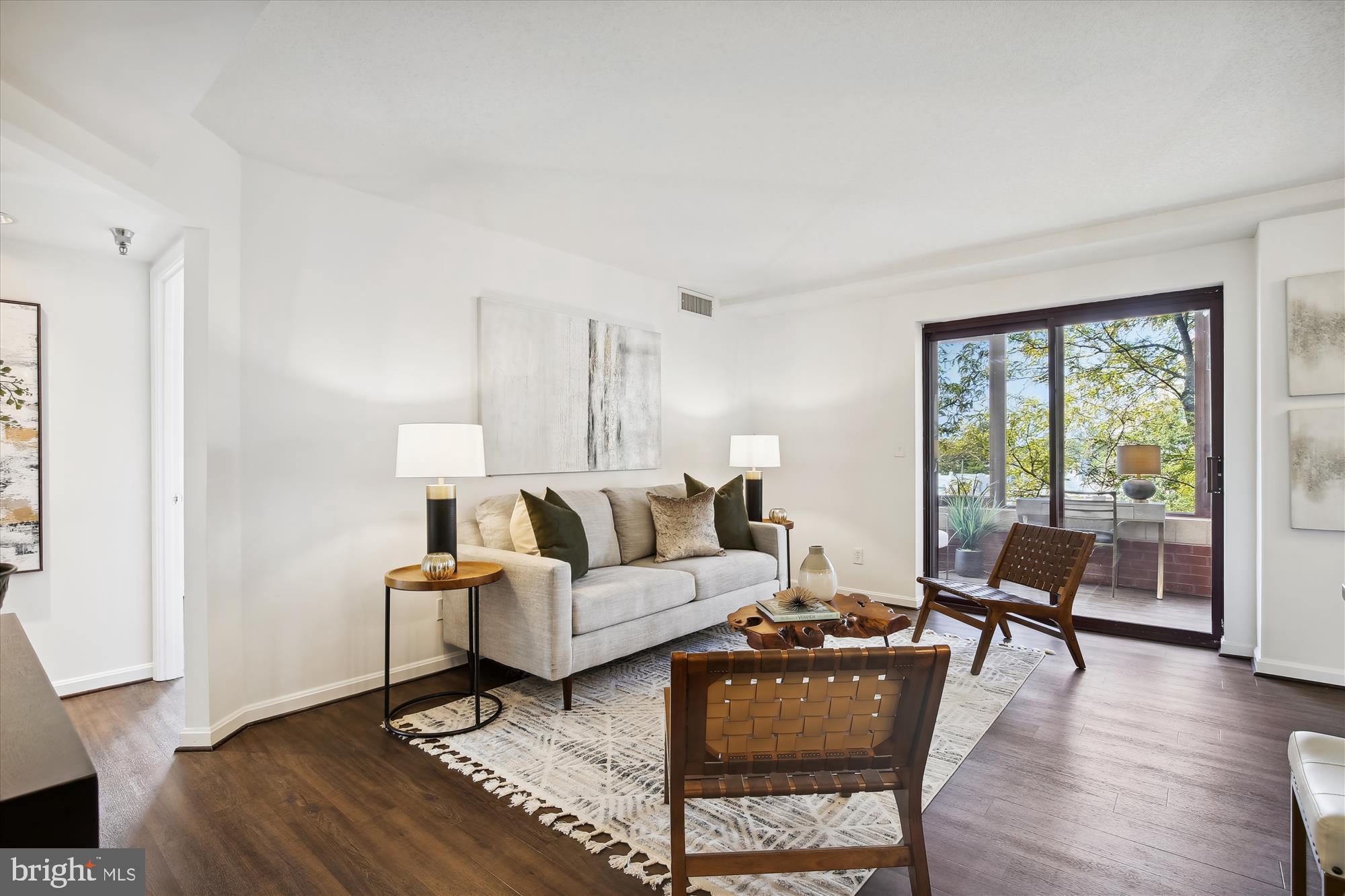 2400 Clarendon Boulevard, Unit 414 Arlington, VA 22201 - Photo 9 of 39 a living room with furniture and a large window
