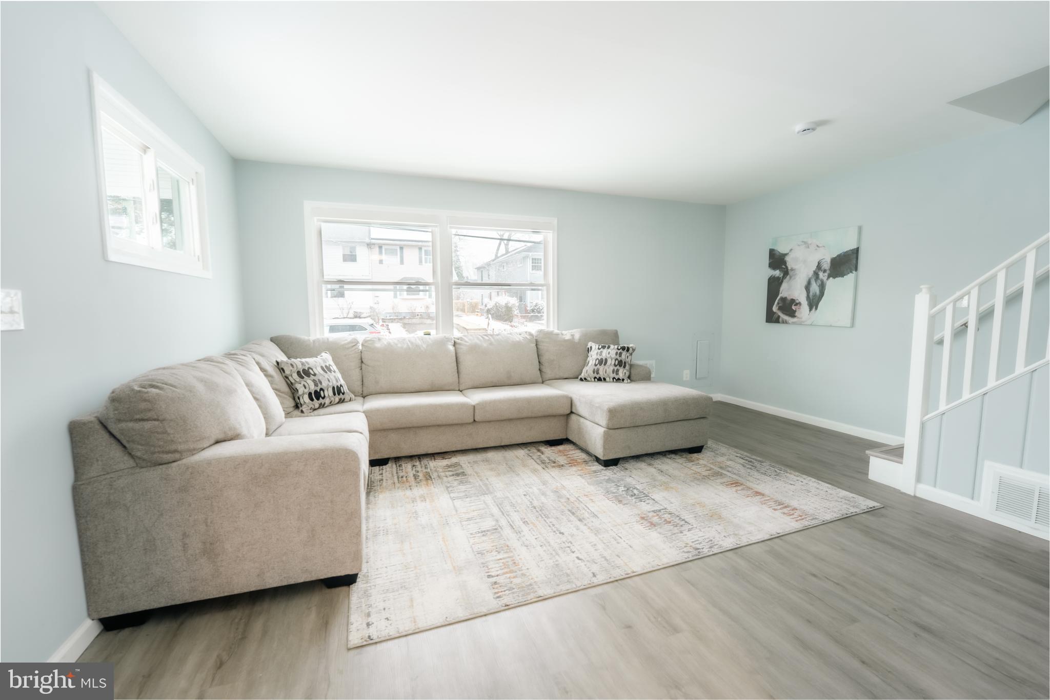 3410 Embry Street Silver Spring, MD 20902 - Photo 26 of 28 a spacious bedroom with a bed a couch and a window