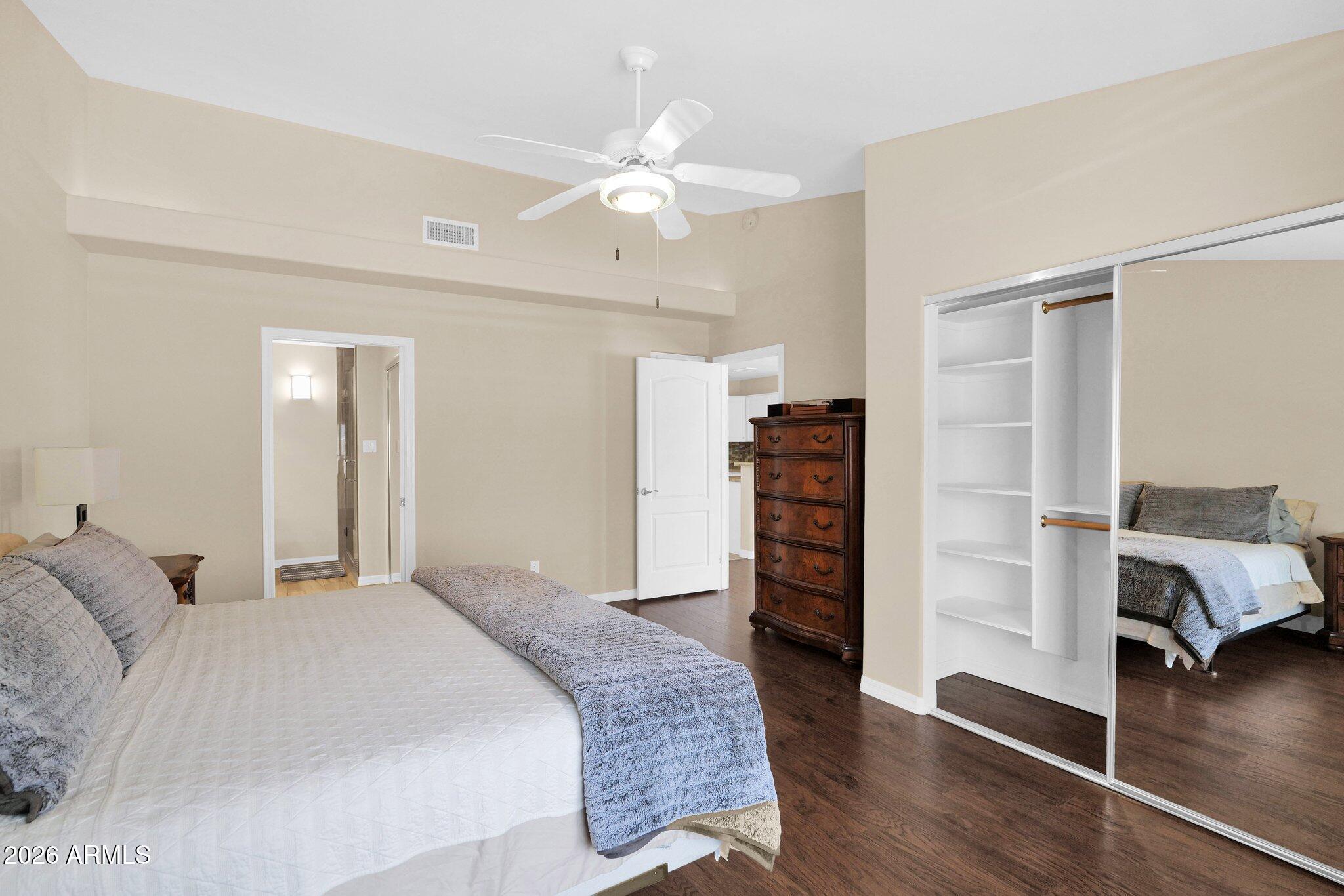 5830 East McKellips Road, Unit 110 Mesa, AZ 85215 - Photo 22 of 45 a bedroom with a bed and a wooden floor