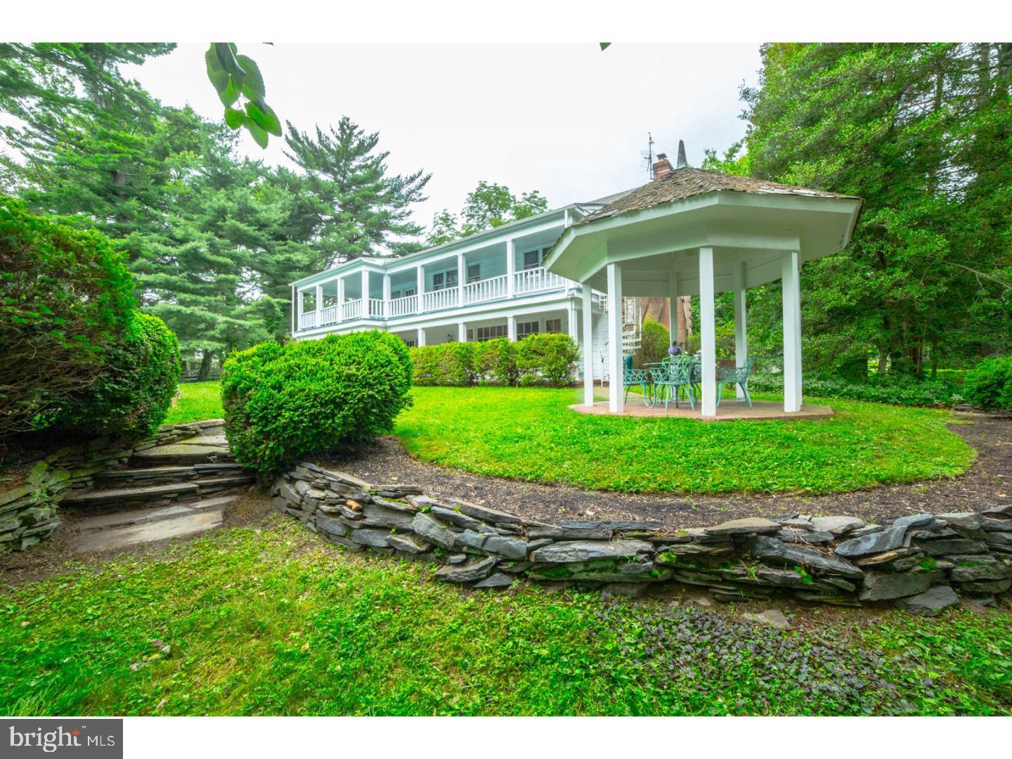 30 Lane Of Acres Haddonfield, NJ 08033 - Photo 3 of 8 a front view of a house with a yard table and chairs