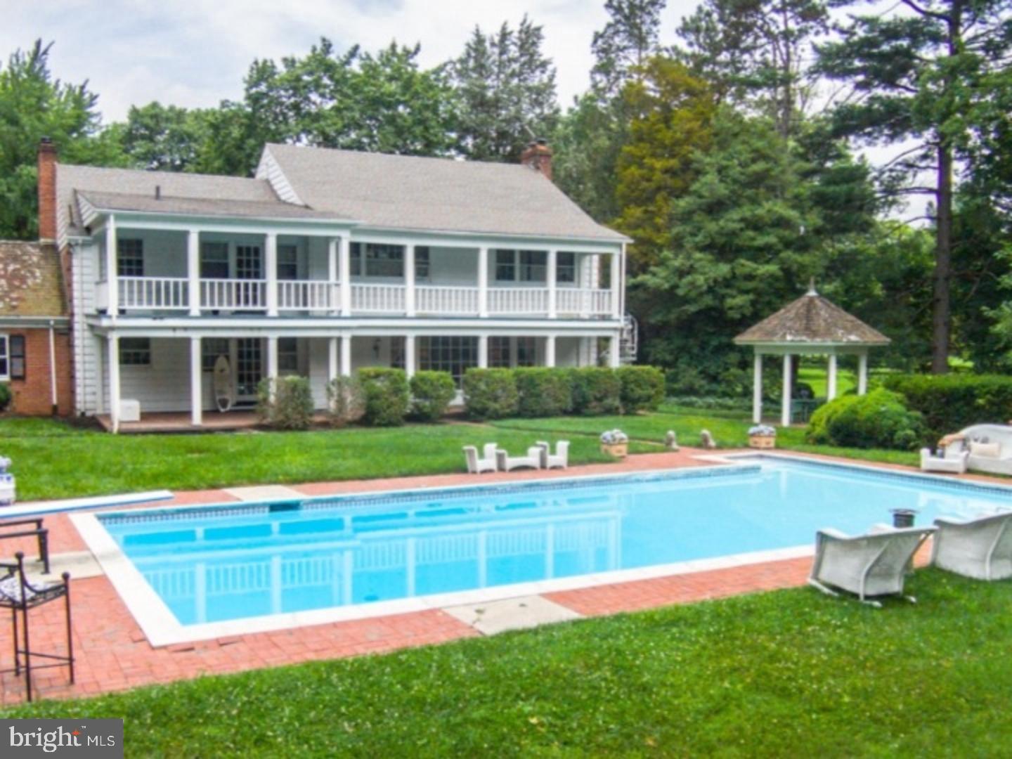 30 Lane Of Acres Haddonfield, NJ 08033 - Photo 5 of 8 a front view of a house with a yard table and chairs