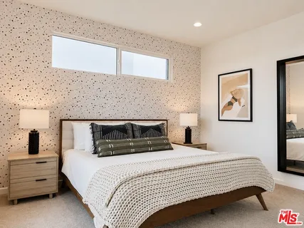 a bedroom with a bed and ceiling fan
