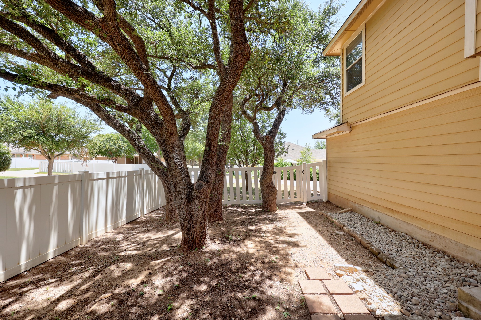 1818 Lost Maples Loop Cedar Park, TX 78613 - Photo 28 of 38 Mature trees provide ample shade to this private yard, complete with a charming picket fence and gate.