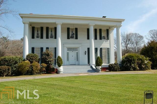 928 Eatonton Road Madison, GA 30650 - Photo 1 of 1 a front view of a house with garden