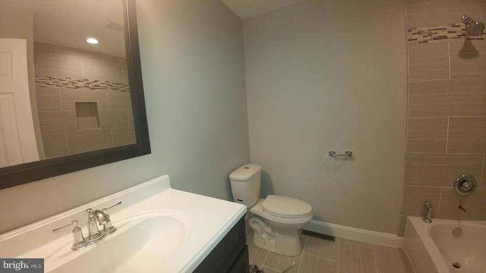 24411 Morgan Road Hollywood, MD 20636 - Photo 14 of 28 a bathroom with a sink toilet and shower
