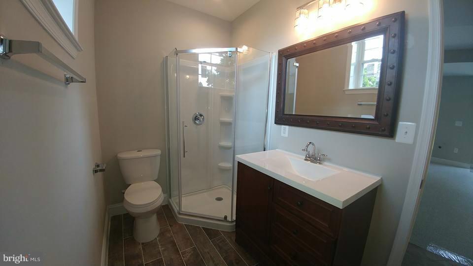 24411 Morgan Road Hollywood, MD 20636 - Photo 20 of 28 a bathroom with a toilet sink and mirror