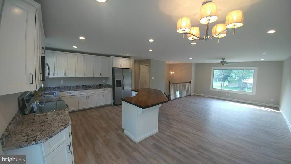 24411 Morgan Road Hollywood, MD 20636 - Photo 3 of 28 a kitchen with a sink and chandelier