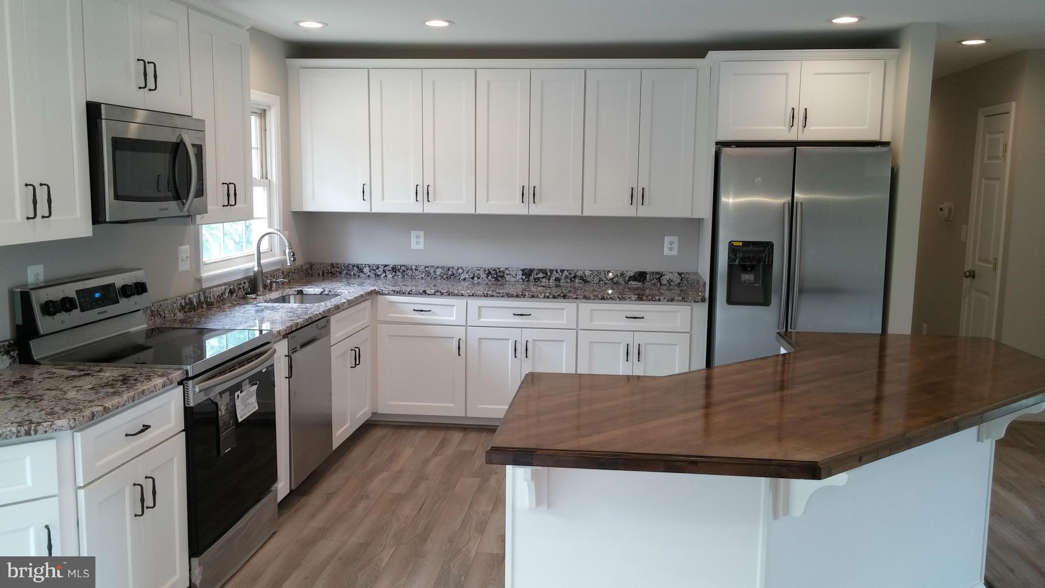 24411 Morgan Road Hollywood, MD 20636 - Photo 4 of 28 a kitchen with a sink stove and refrigerator