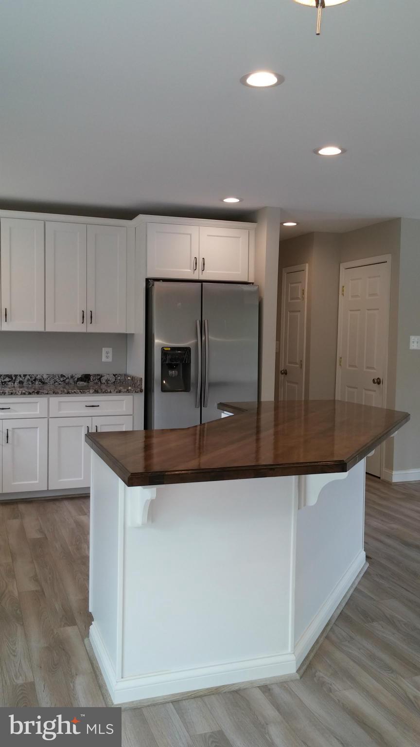 24411 Morgan Road Hollywood, MD 20636 - Photo 10 of 28 a kitchen with stainless steel appliances granite countertop a white stove top oven and cabinets
