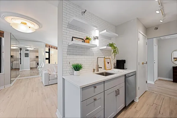 a spacious bathroom with a granite countertop sink and a mirror