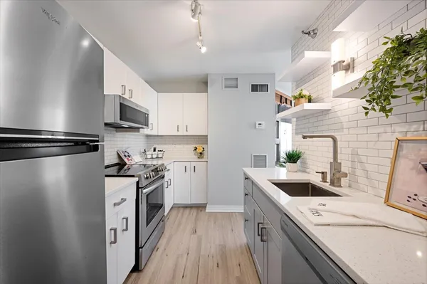 a kitchen with a sink stove and refrigerator