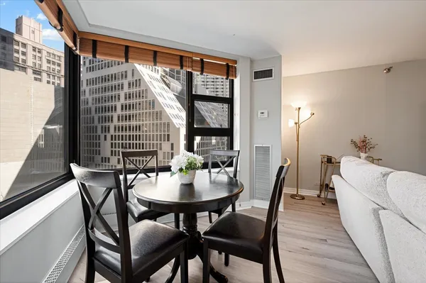 a dining room with furniture and window