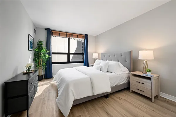 a bedroom with a bed and a window