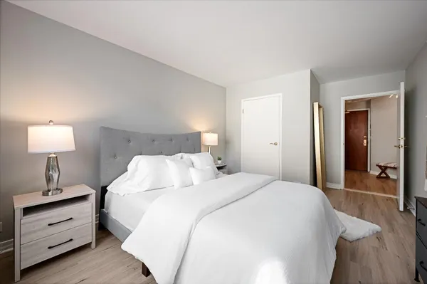 a bedroom with a bed and a lamp