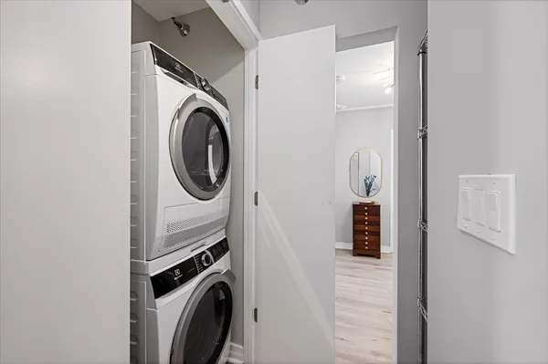 a utility room with dryer washer and a view of bathroom