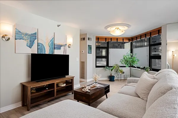 a living room with furniture and a flat screen tv