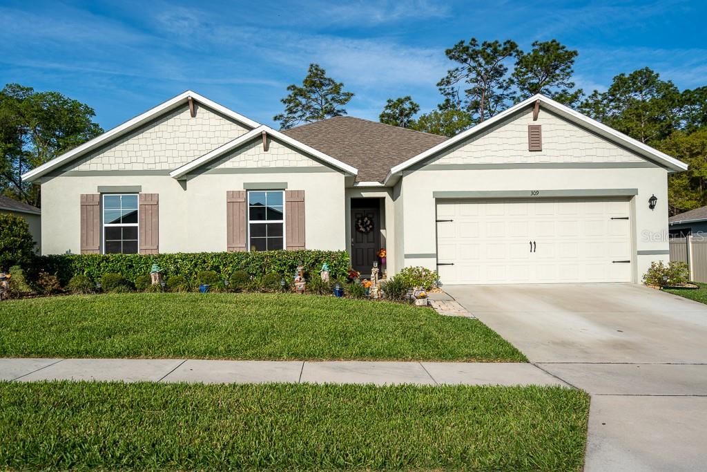a view of a yard in front view of a house