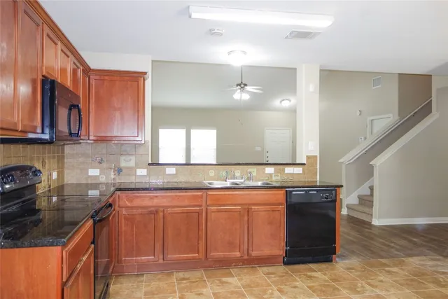 a kitchen with a sink and cabinets