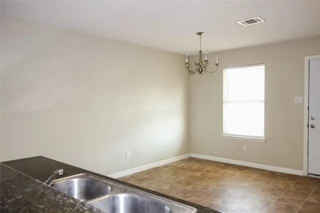 a view of a room with window and ceiling fan