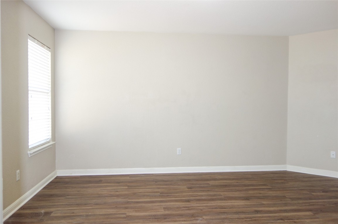 108 Lavaca Loop Hutto, TX 78634 - Photo 15 of 39 a view of an empty room with wooden floor and a window