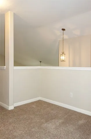 a view of a room with wooden floor and a ceiling fan
