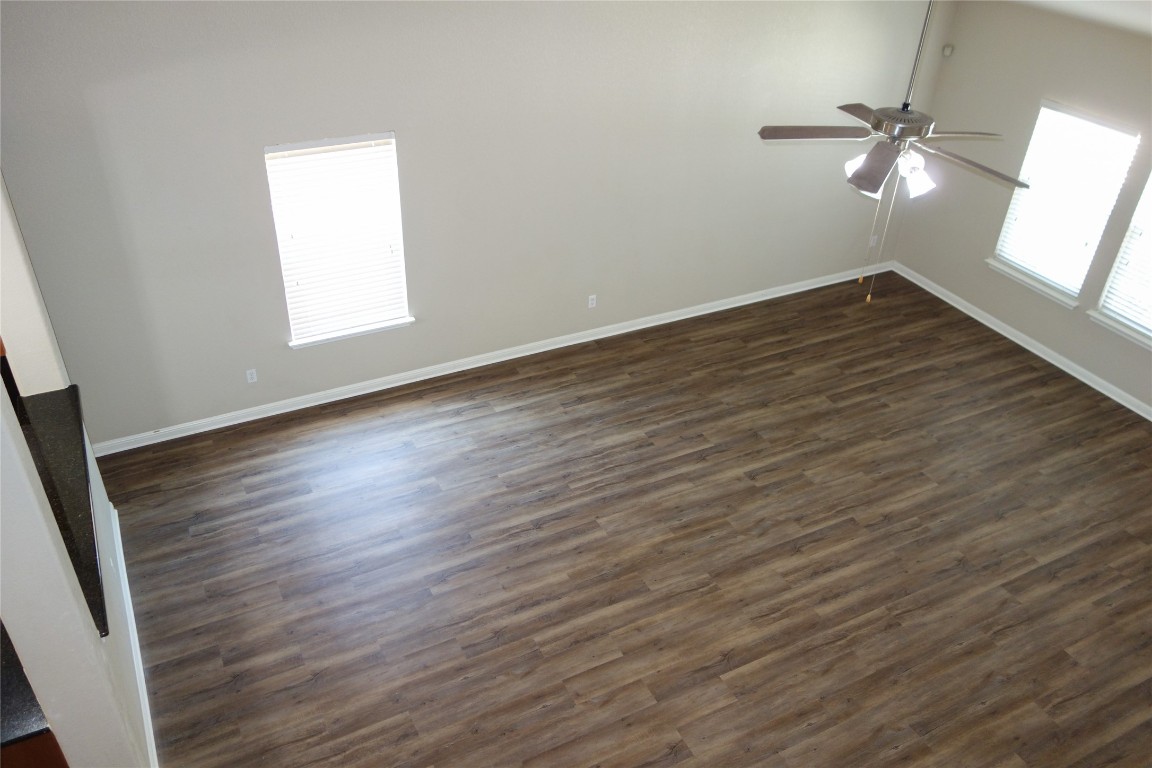 108 Lavaca Loop Hutto, TX 78634 - Photo 32 of 39 an empty room with wooden floor and windows