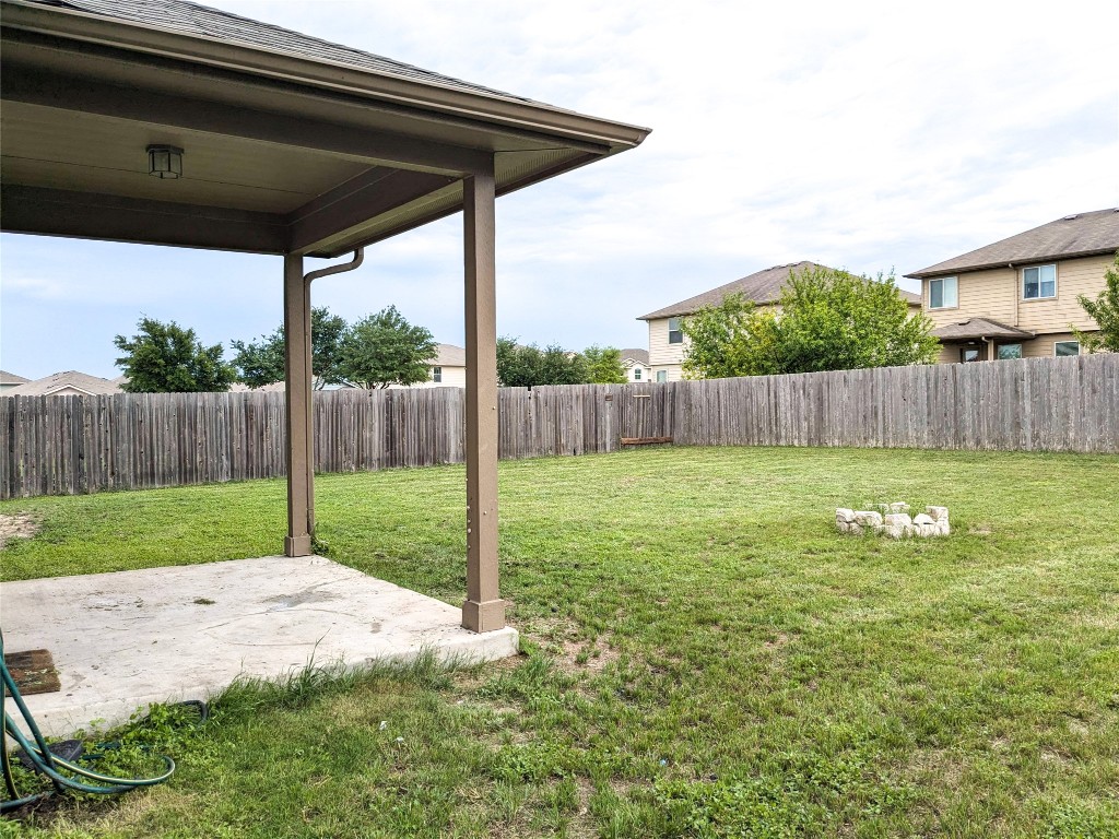 108 Lavaca Loop Hutto, TX 78634 - Photo 33 of 39 a view of a backyard with a garden and wooden fence