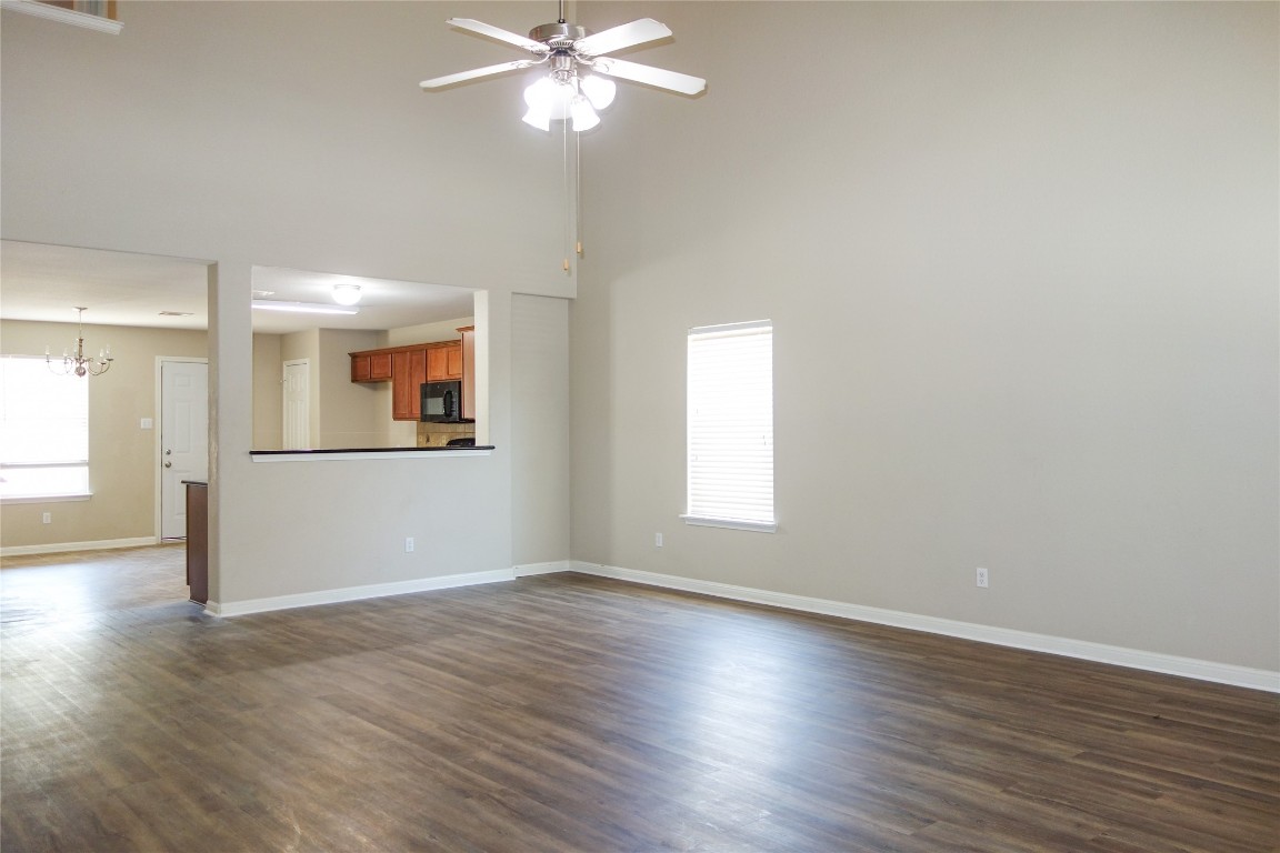108 Lavaca Loop Hutto, TX 78634 - Photo 6 of 39 a view of an empty room with wooden floor and a window