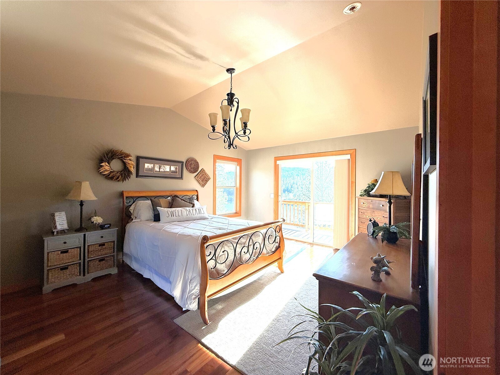 8 Julian Bay Road Republic, WA 99166 - Photo 9 of 40 a bedroom with a bed and a chandelier