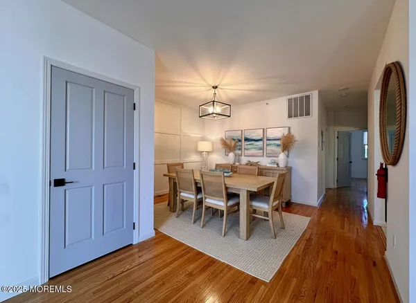 a view of a dining room with furniture wooden floor and a chandelier