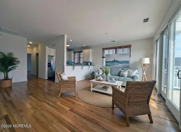 a living room with furniture and a wooden floor