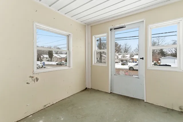 a view of small space with wooden floor and windows