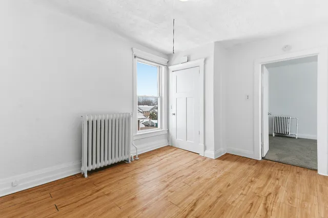 a view of a room with wooden floor
