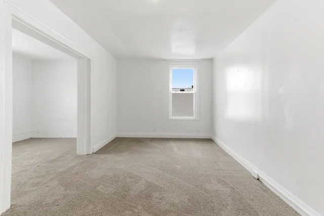 a view of an empty room and a window