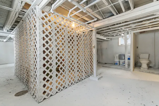 a view of a hallway with wooden fence