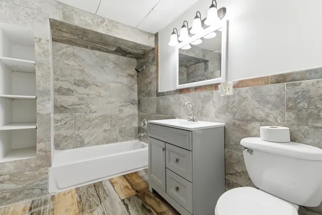 a bathroom with a sink toilet and shower