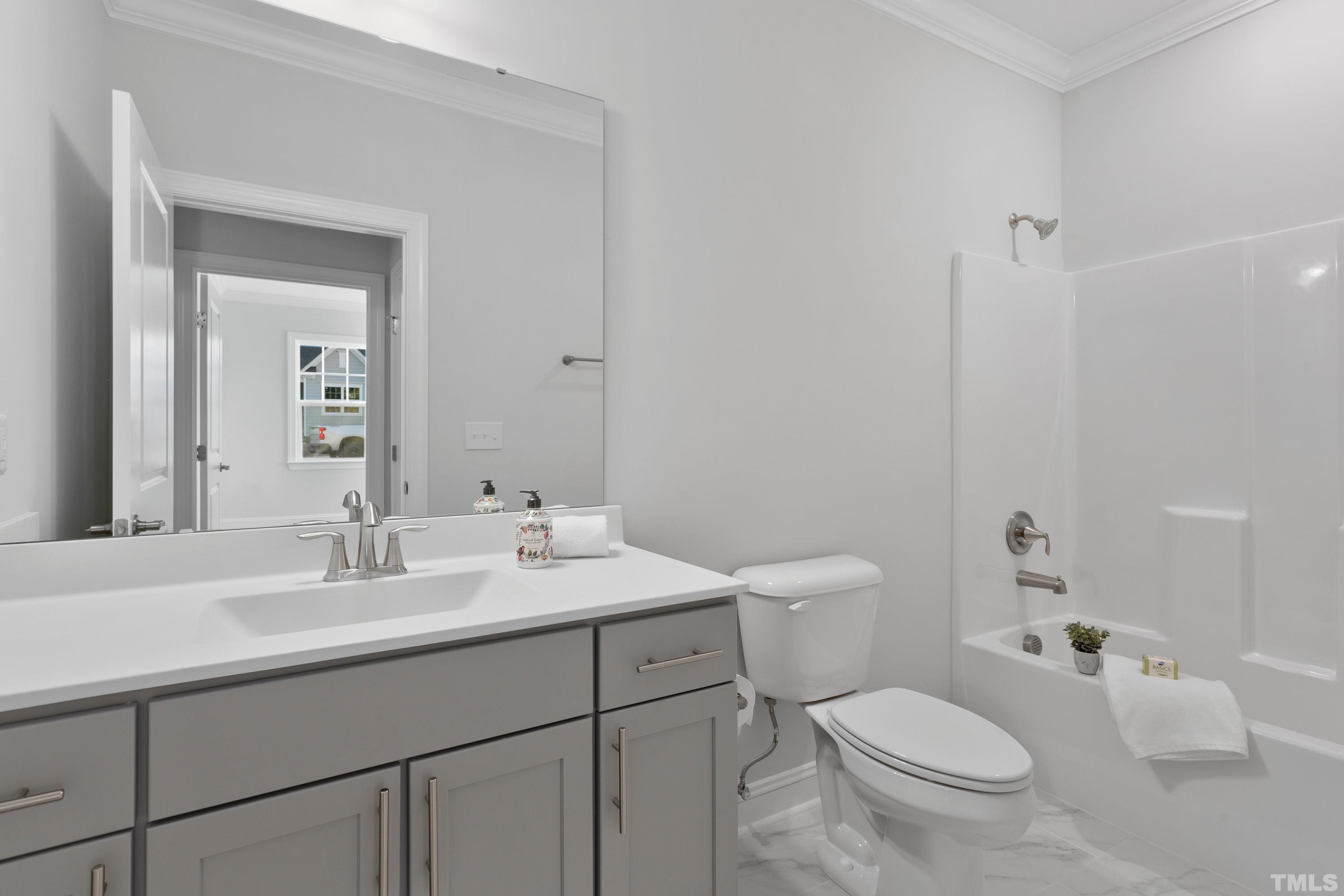 137 English Violet Lane Raleigh, NC 27610 - Photo 20 of 27 a bathroom with a toilet sink and mirror