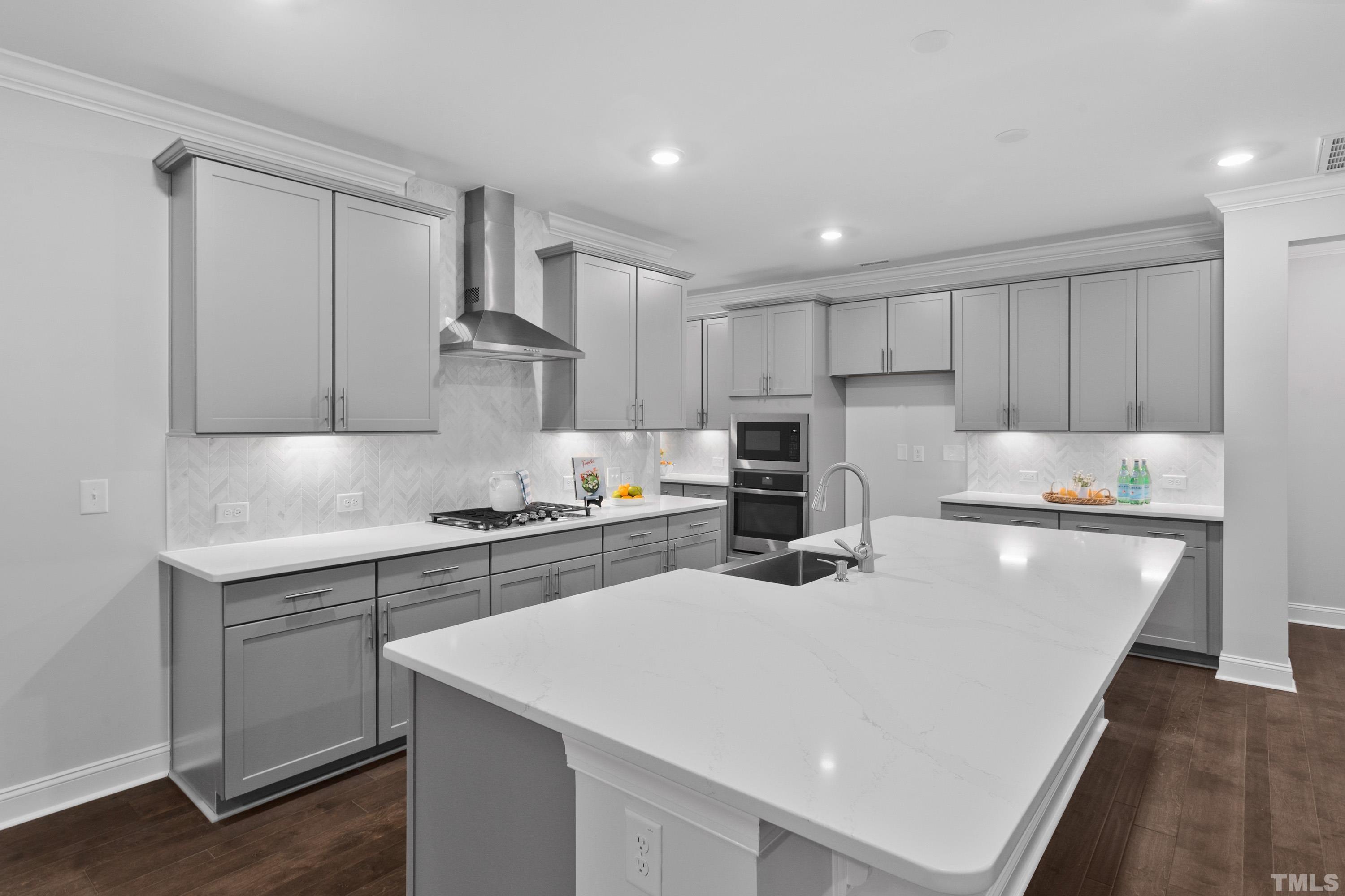 137 English Violet Lane Raleigh, NC 27610 - Photo 3 of 27 a kitchen with stainless steel appliances granite countertop a sink dishwasher a stove and white cabinets with wooden floor